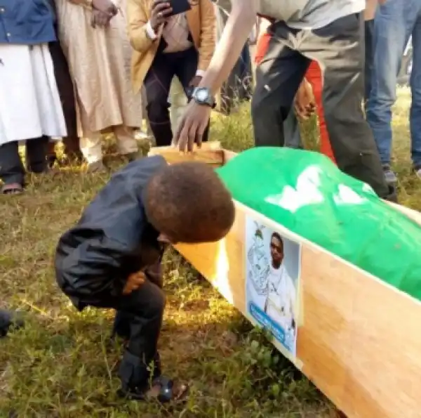 Little Boy Seen Staring At The Photo Of His Dad Killed During The Shiite/Police Clash